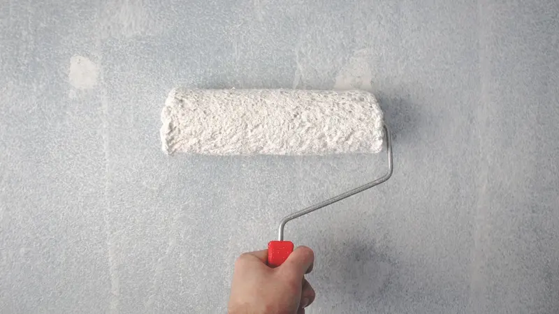 Painting a wall with a roller
